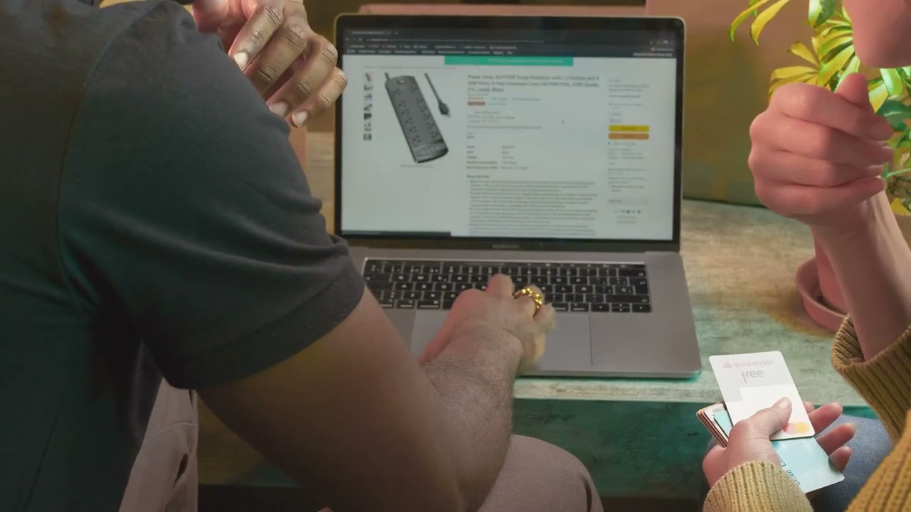 Two people compare products on a laptop.